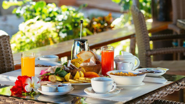 Table with fresh fruits and breakfast items at Boathouse Nanuya, Yasawa Islands