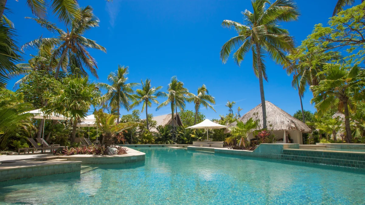 Castaway Island Poolside Fiji scaled Poolside at Castaway Island Resort, Fiji, featuring tropical surroundings and lounge areas.