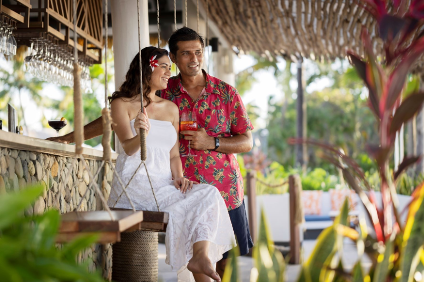 Couple at Suka Bar Saku Bar, Sofitel Resort, Denarau Island, Young Couple, Tropical Attire, Swim Bar Seating, Pebble Frontage of bar