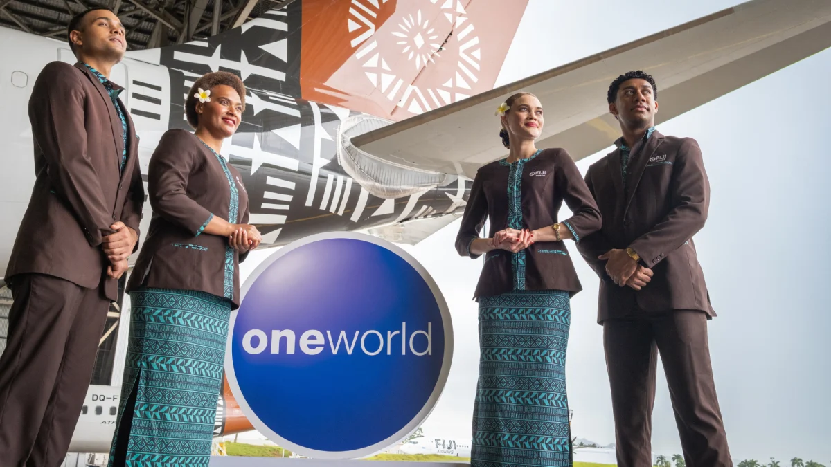 Fiji Airways Crew scaled Fiji Airways crew members in uniform assisting passengers onboard a flight.