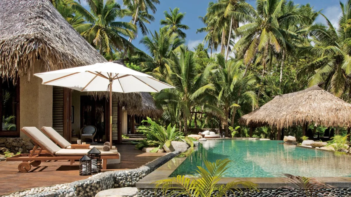 Poolside at Como Laucala Island scaled Poolside with tropical surroundings at COMO Laucala Island Fiji.